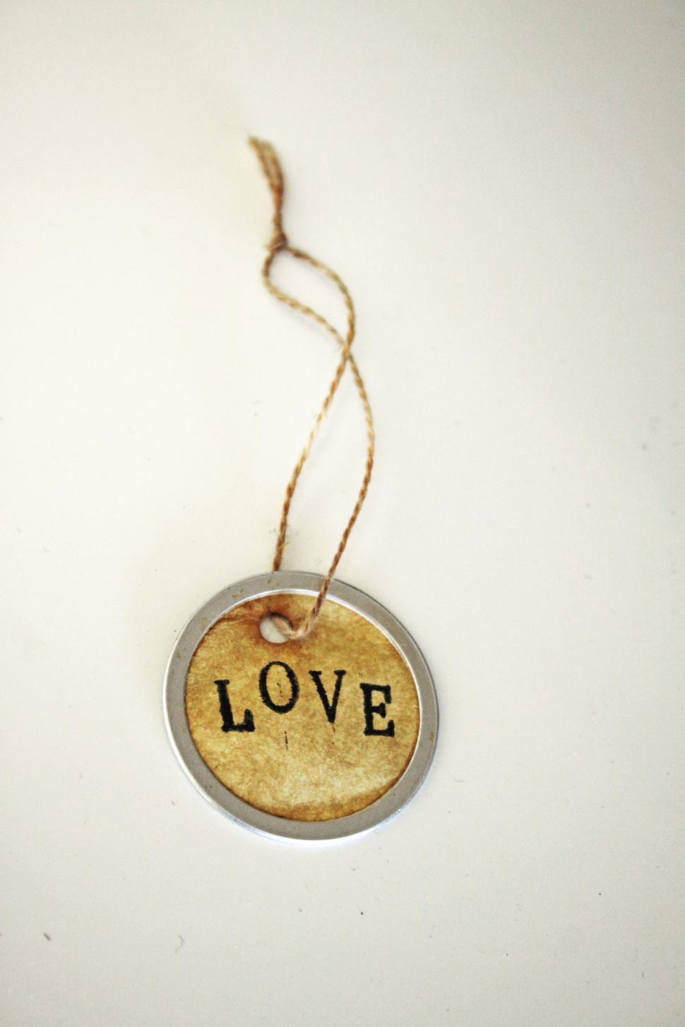 Free Image of Rustic love tag dangling on twine 