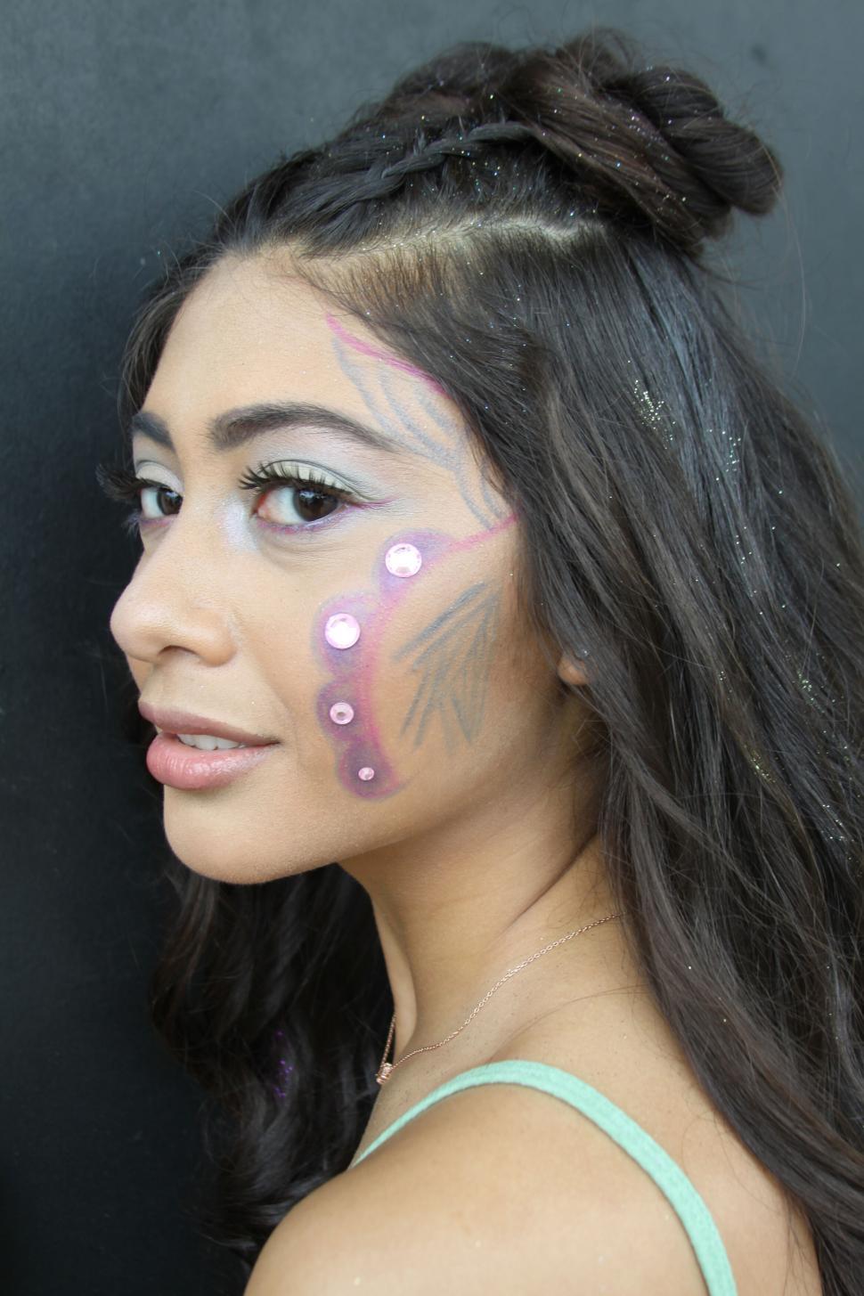 Free Image of Woman with face paint and glitter 
