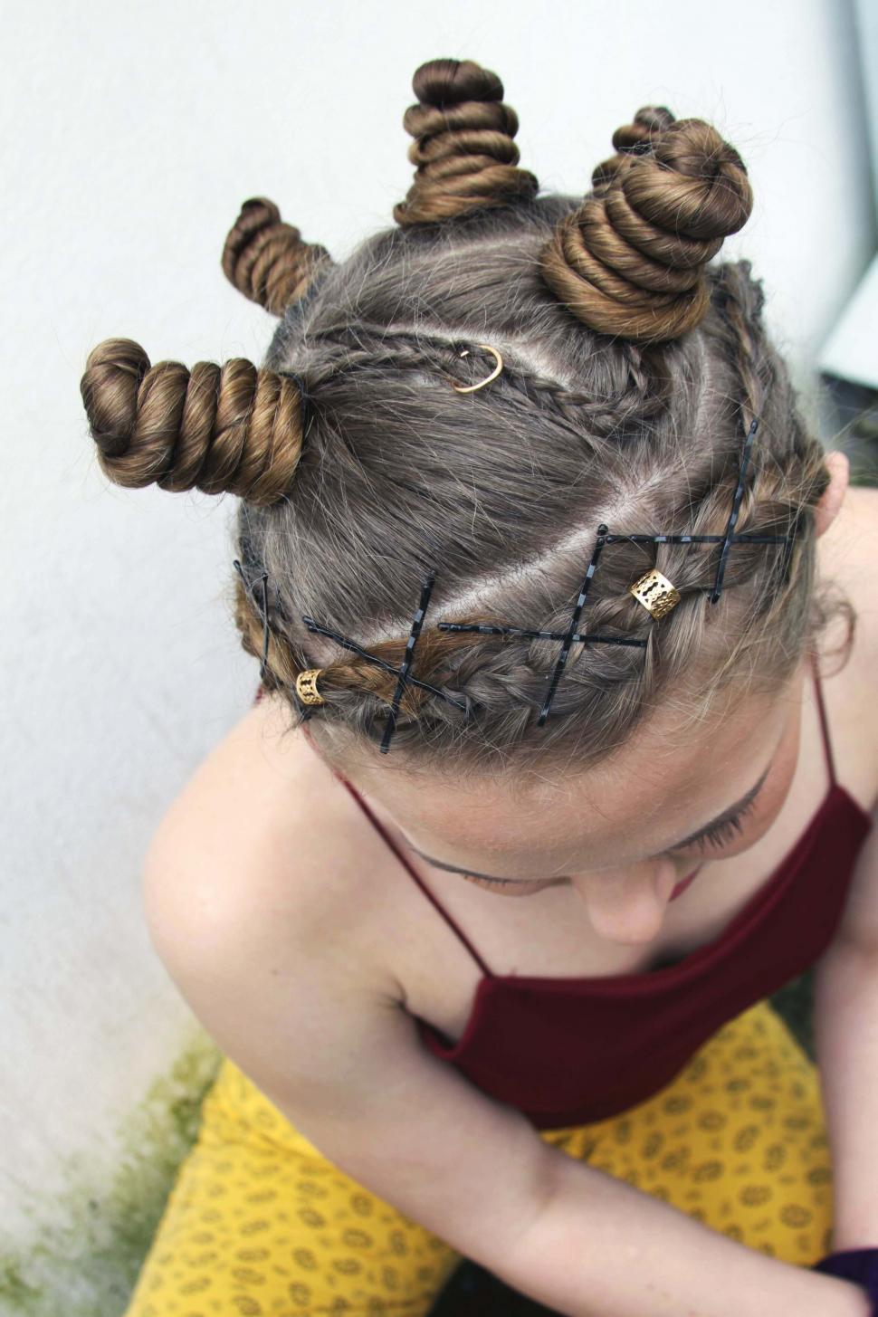 Free Image of Creative hairstyle with buns and braids 