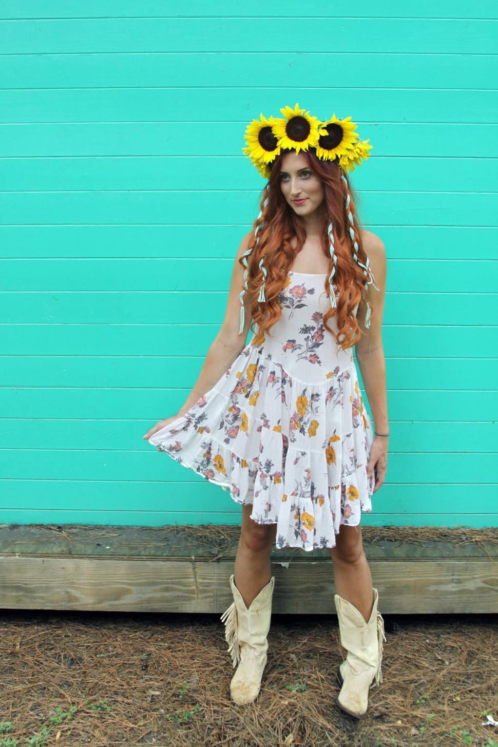 Free Image of Woman with sunflower headband standing 