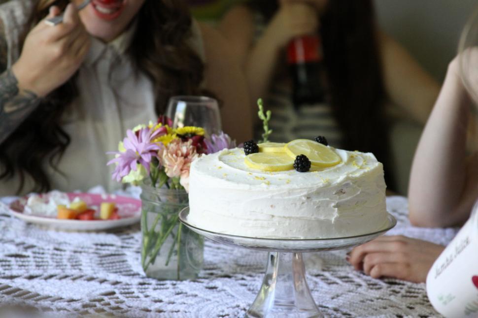 Free Image of Celebratory cake on table with woman laughing 