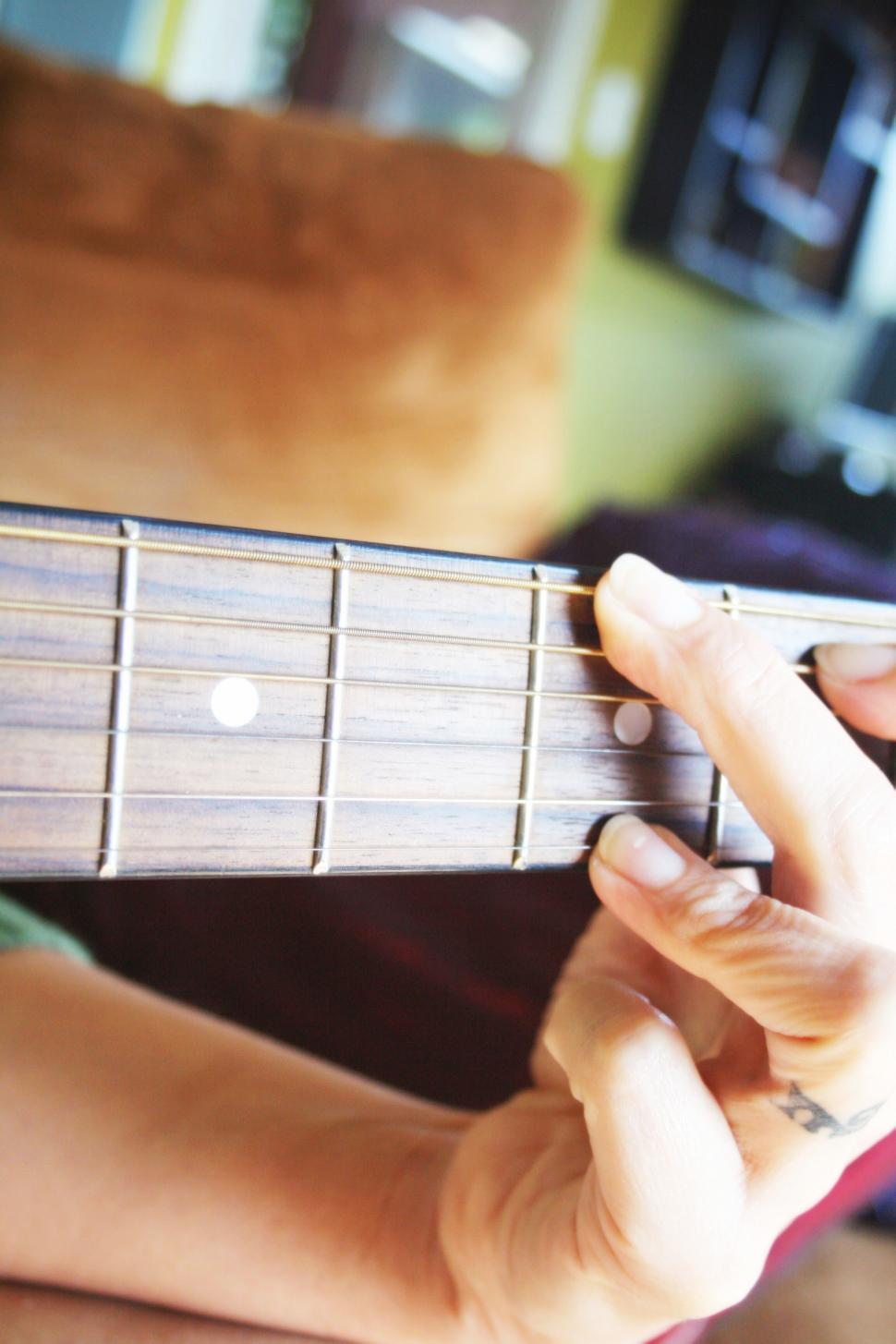 Free Image of Close-up of hand playing acoustic guitar 