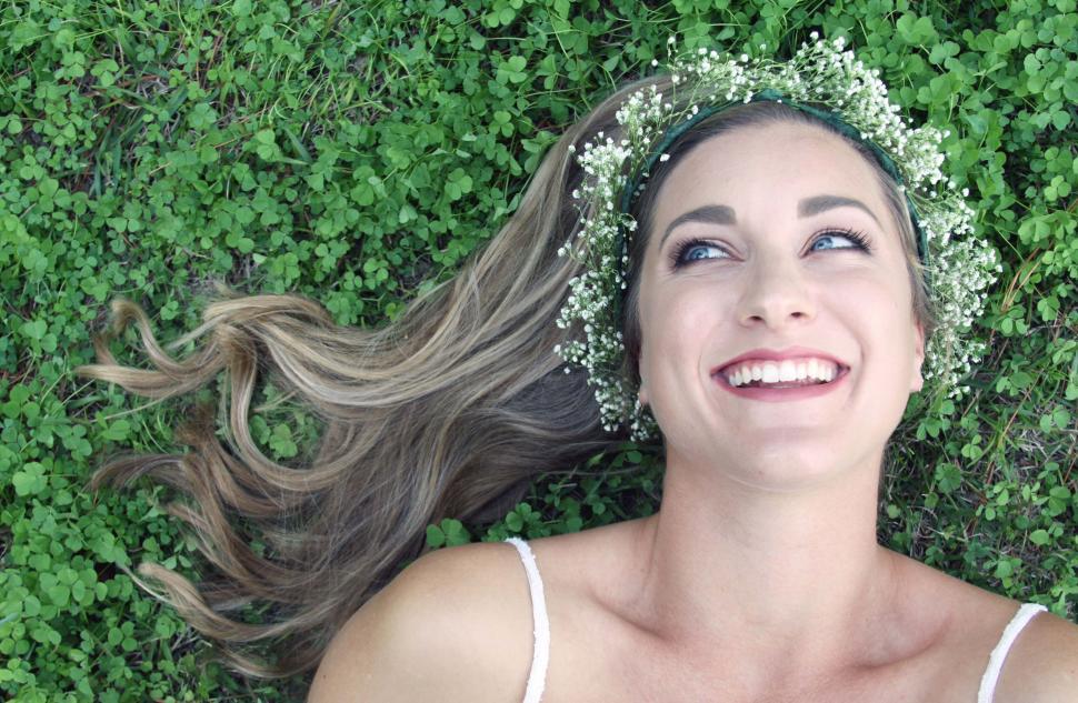 Free Image of Smiling woman lying on green grass 