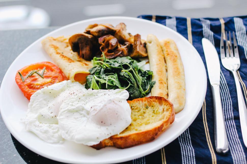 Free Image of Hearty breakfast plate on striped tablecloth 
