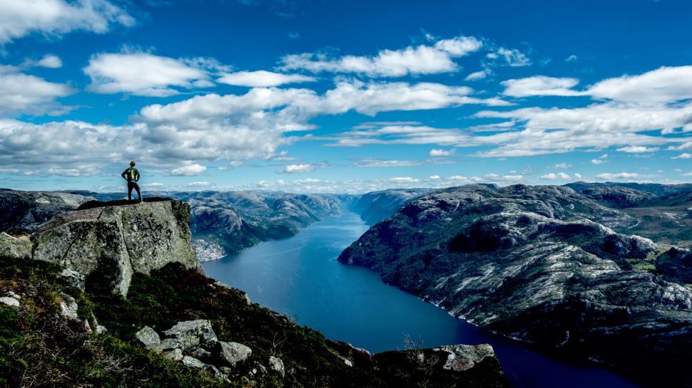 Free Image of Hiker overlooking majestic Norwegian fjords 