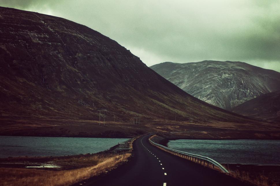 Free Image of Moody landscape of road winding through hills 