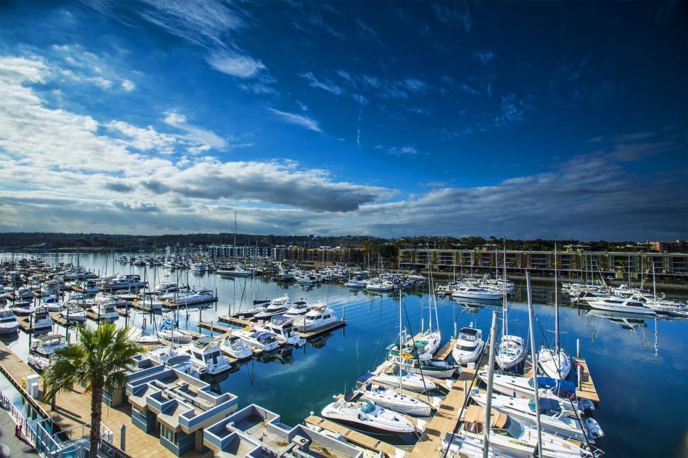 Free Image of Vibrant marina with luxury yachts on clear day 