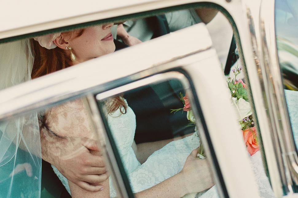 Free Image of Bride in vintage car with blurred face 