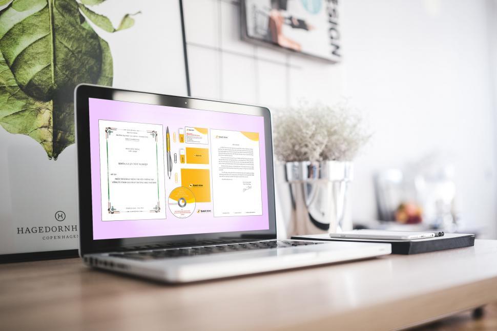 Free Image of Laptop on desk with branding presentation 