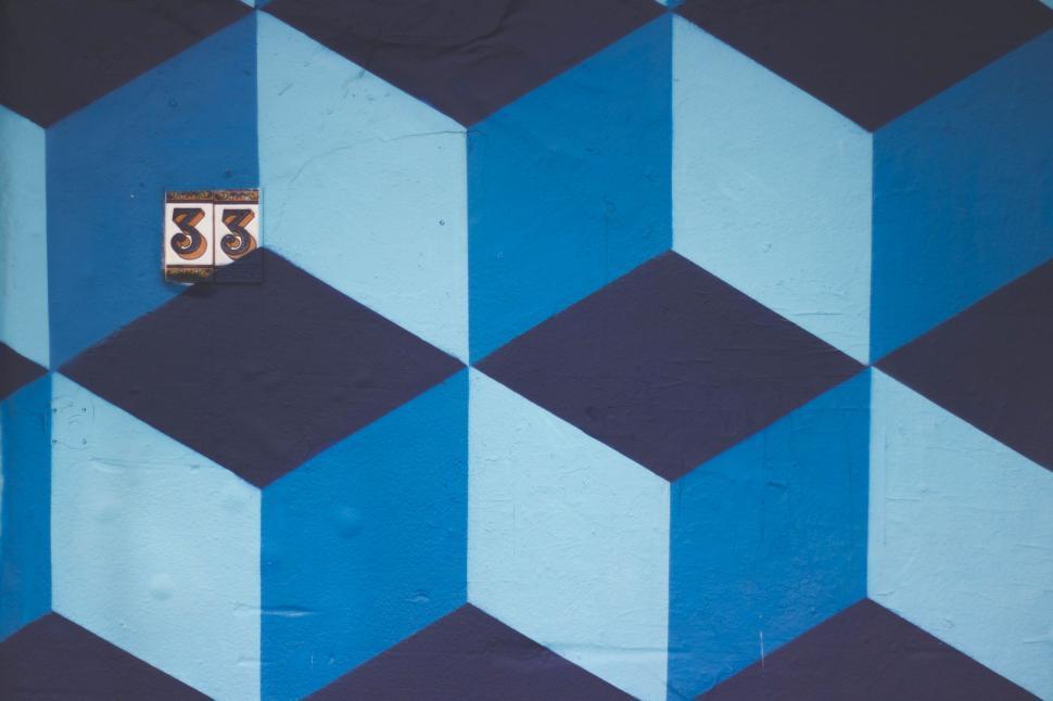 Free Image of Abstract blue and white geometric wall with 33 