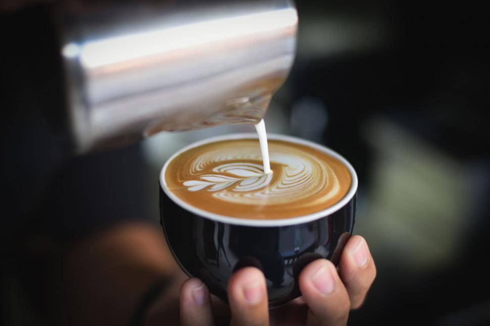 Free Image of Art of pouring milk into coffee captured 