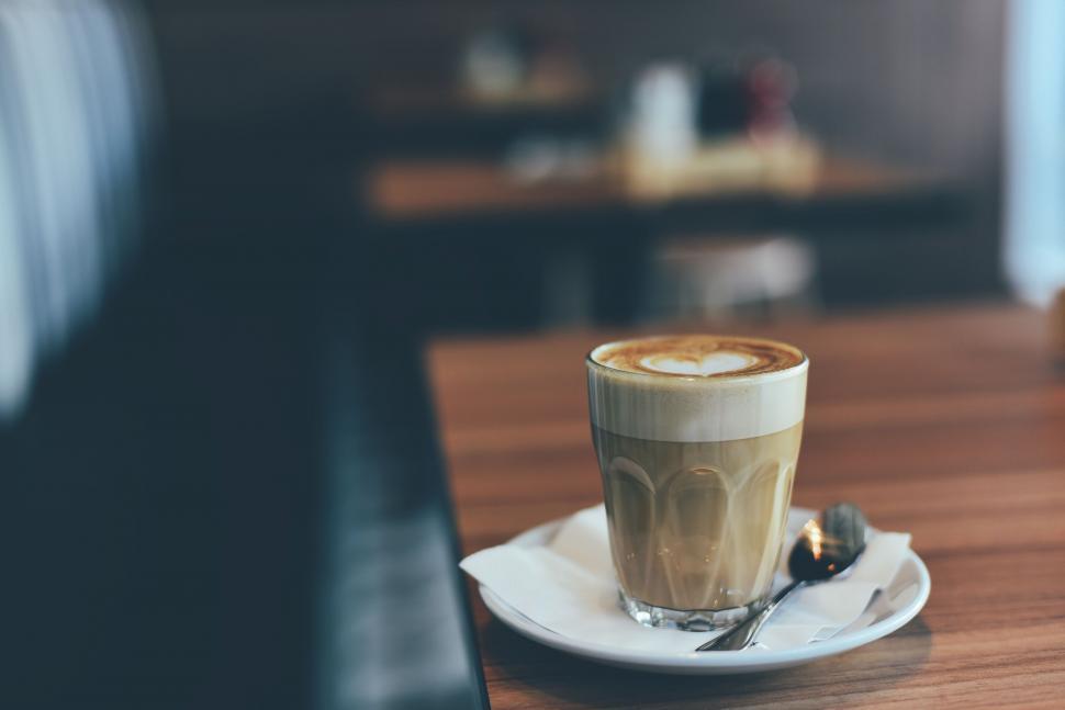 Free Image of Coffee cup on table with blurred background 