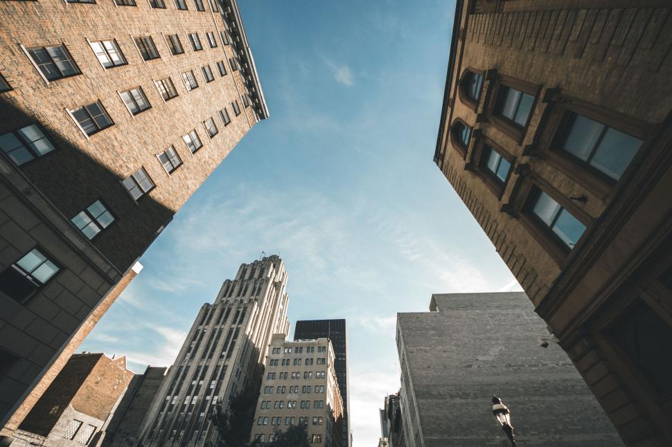 Free Image of Upward view of urban buildings and blue sky 