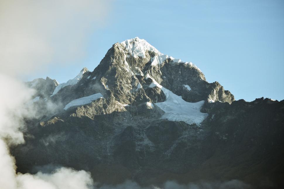 Free Image of Mighty mountain with snowy cap and clouds 