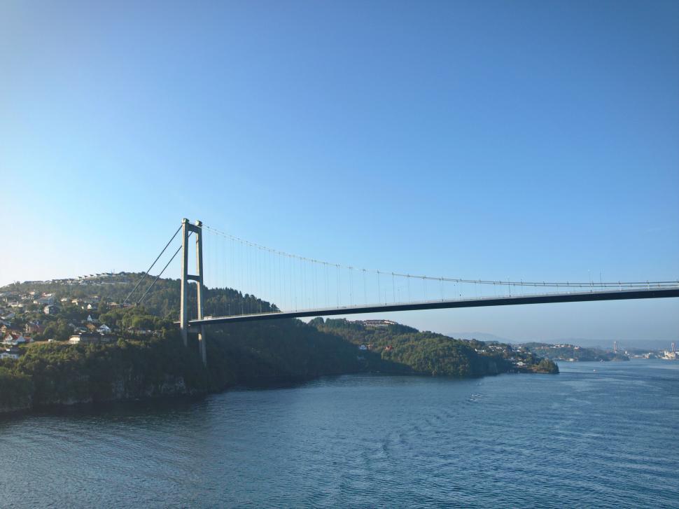 Free Image of Suspended bridge over a scenic fjord 