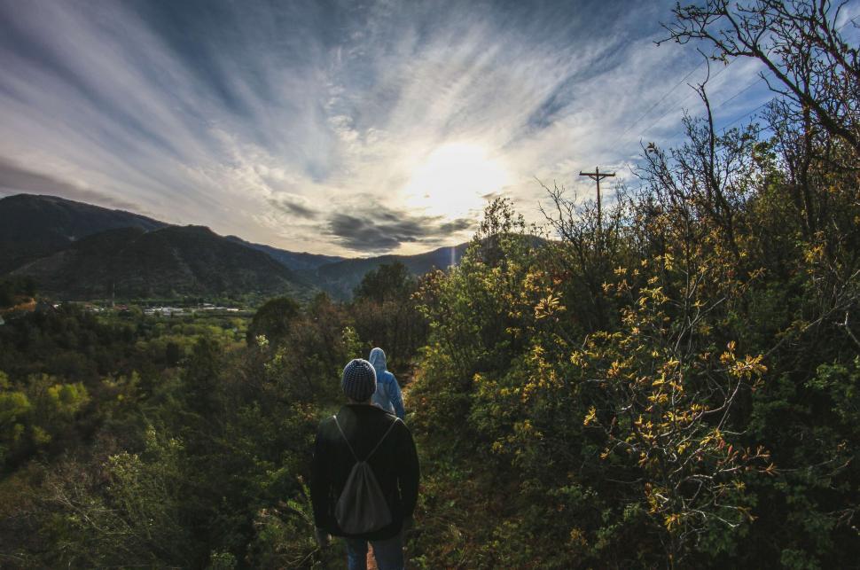 Free Image of Person hiking towards a sunset in nature 