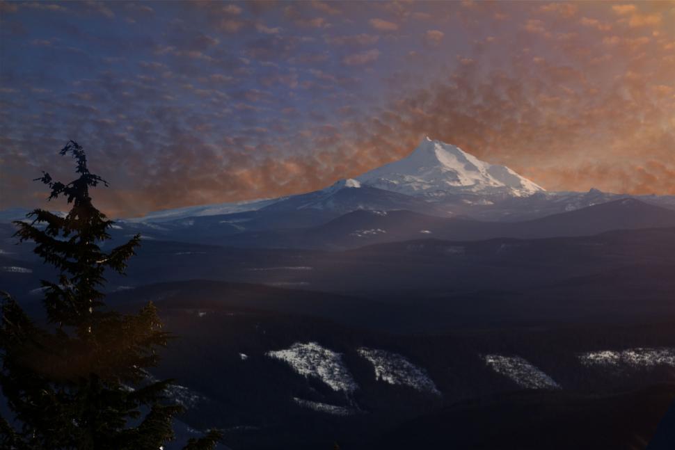 Free Image of Sunset glow over a snowy mountain peak 