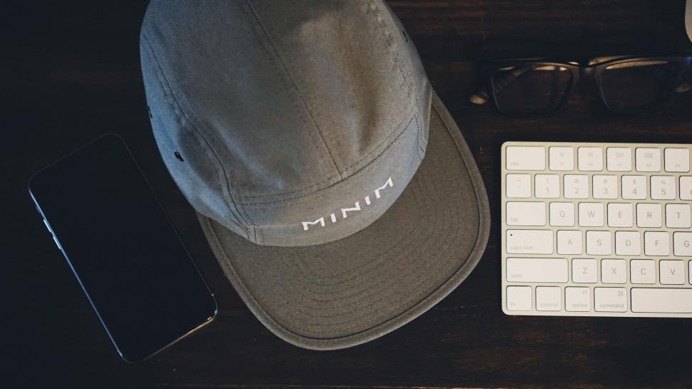 Free Image of Desk with electronics and branded cap 