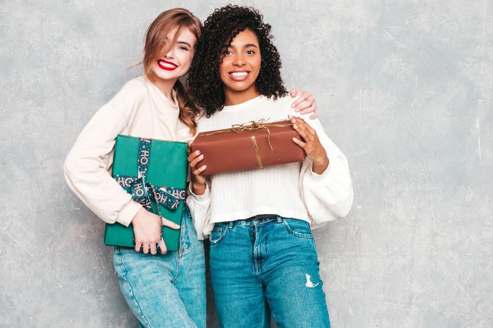 Free Image of Two women holding presents 