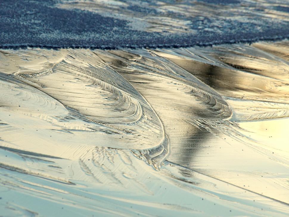 Free Image of Abstract patterns on the icy beach sands 