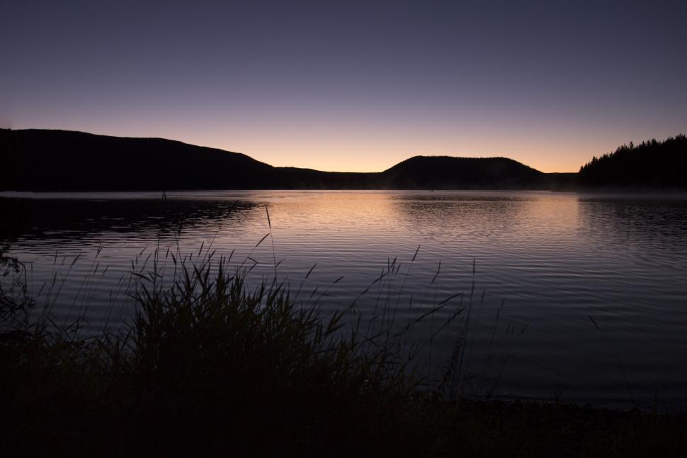 Free Image of Tranquil dawn over a forested lake 