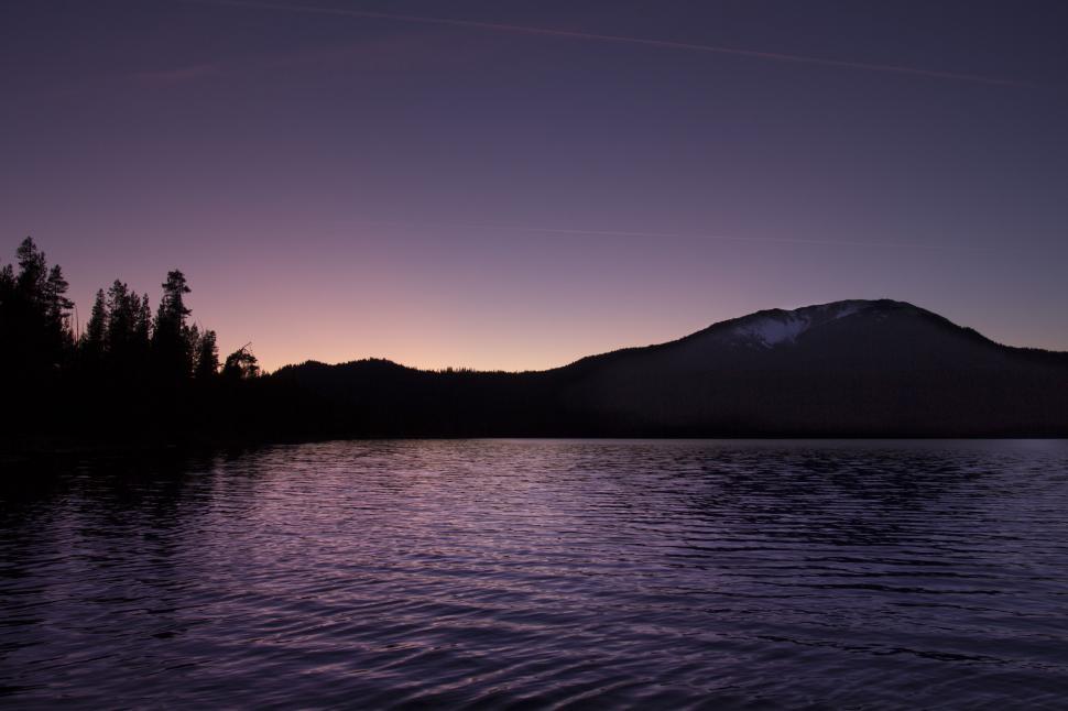 Free Image of Twilight hues over mountain and forest lake 