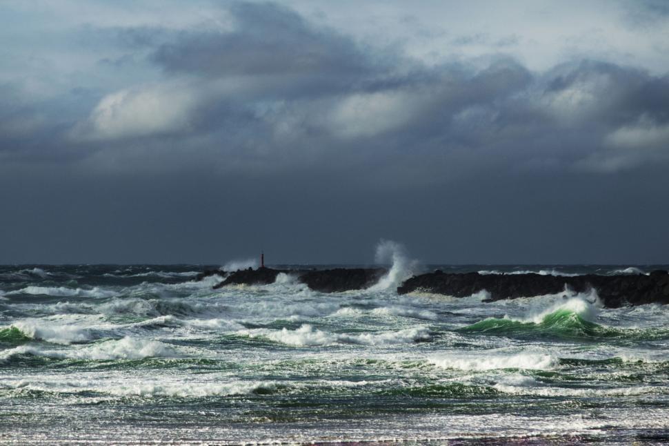 Free Image of Rough sea with waves breaking on rocky barrier 