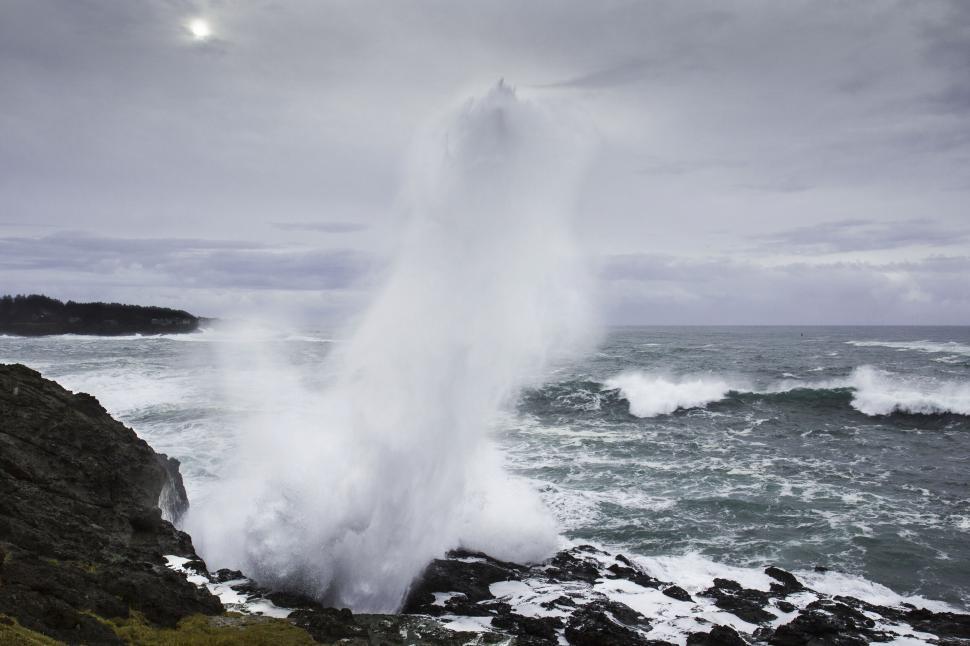 Free Image of Massive wave crashing against rocky shore 