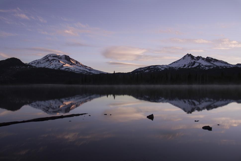 Free Image of Calm lake mirroring mountain and sunset sky 