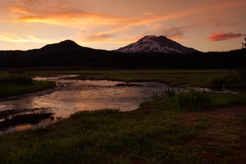 Free Image of Sunset glow over a mountain and stream 