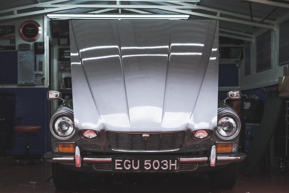 Free Image of Classic car with hood open in garage 