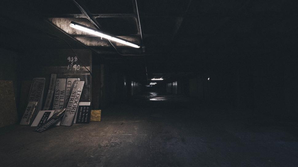 Free Image of Dimly lit underground parking with graffiti 