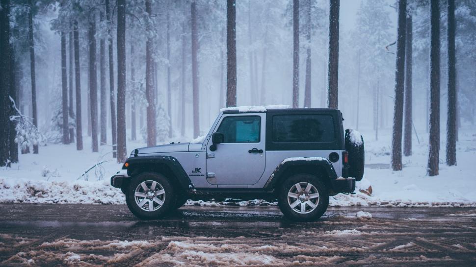 Free Image of Jeep in a snowy forest scene 