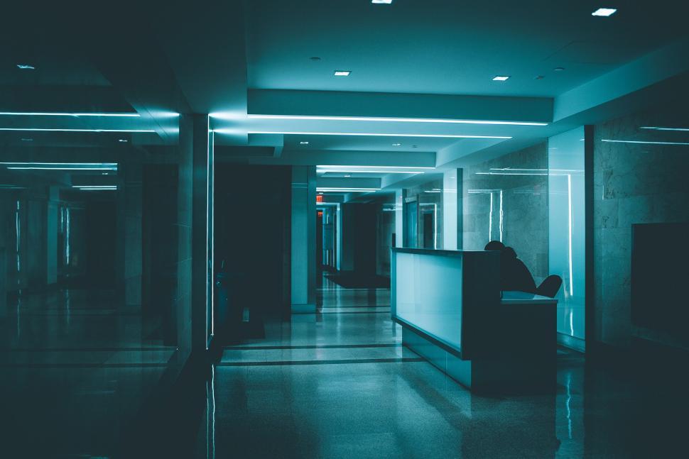 Free Image of Modern office hallway with blue ambient lighting 