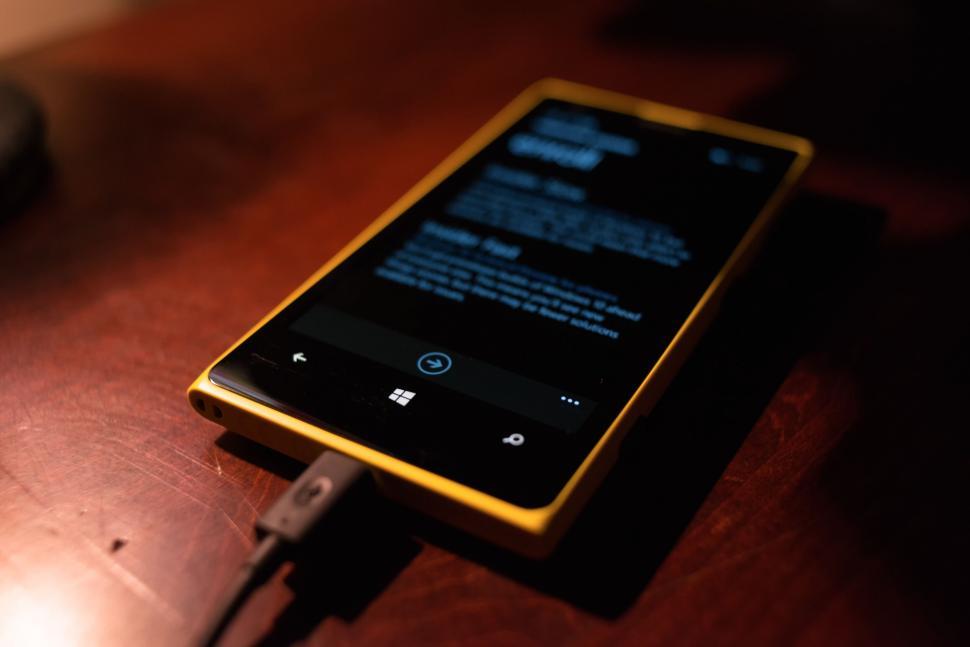Free Image of Smartphone with music player on screen charging 