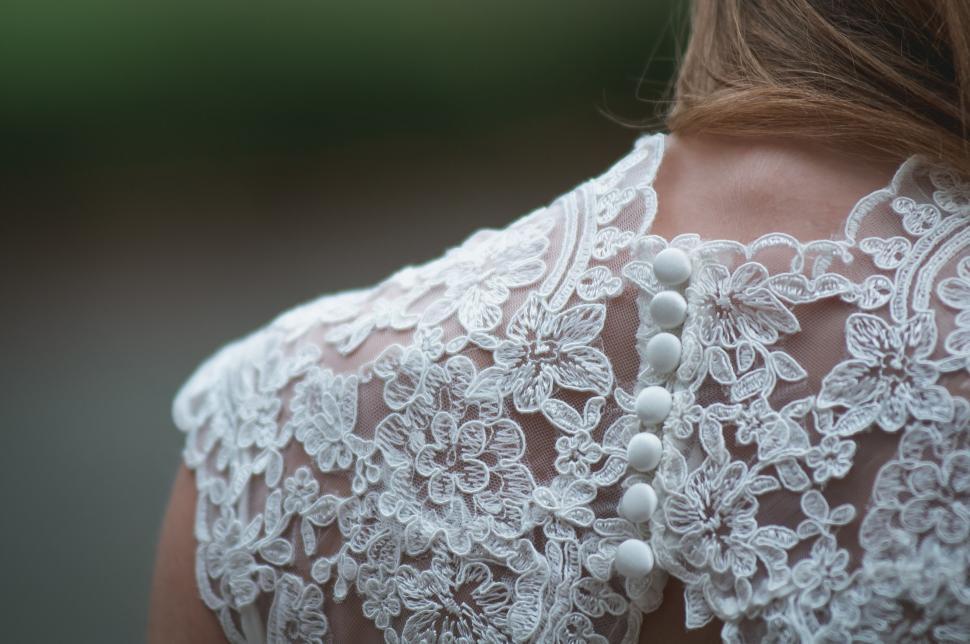 Free Image of Close-up of white lace dress detail 