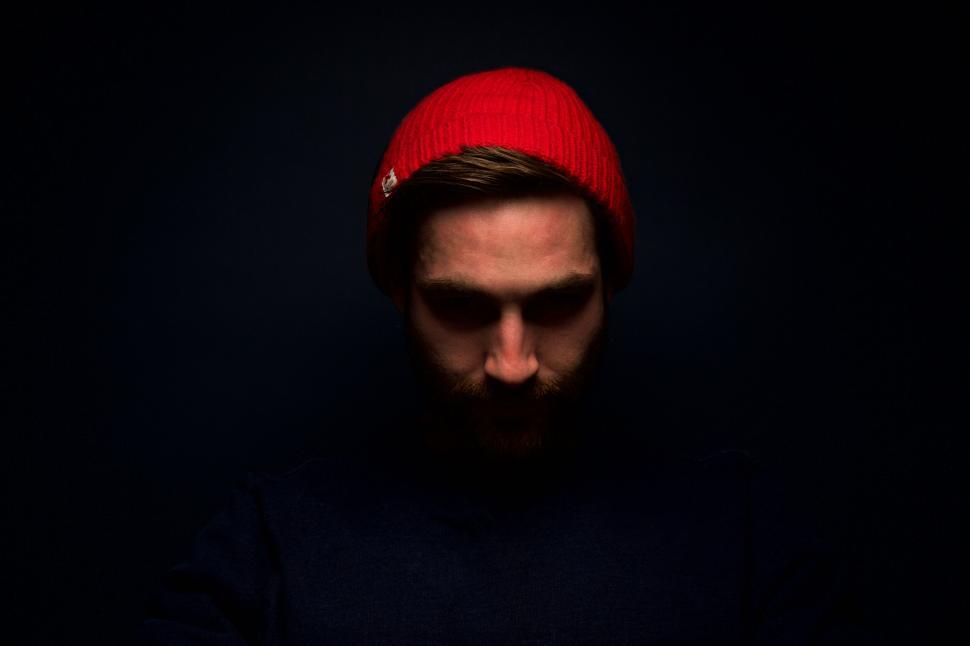 Free Image of Moody portrait of a man wearing red beanie 