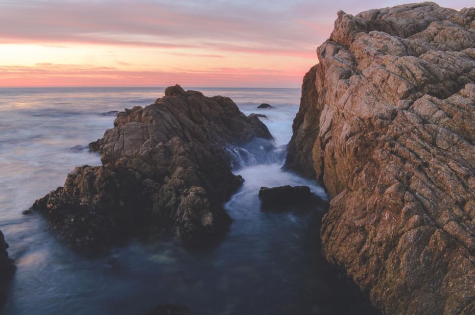 Free Image of Sunset over rugged ocean cliffs 