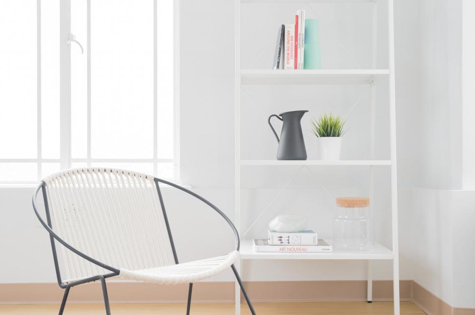 Free Image of Minimalistic white chair and bookshelf corner 
