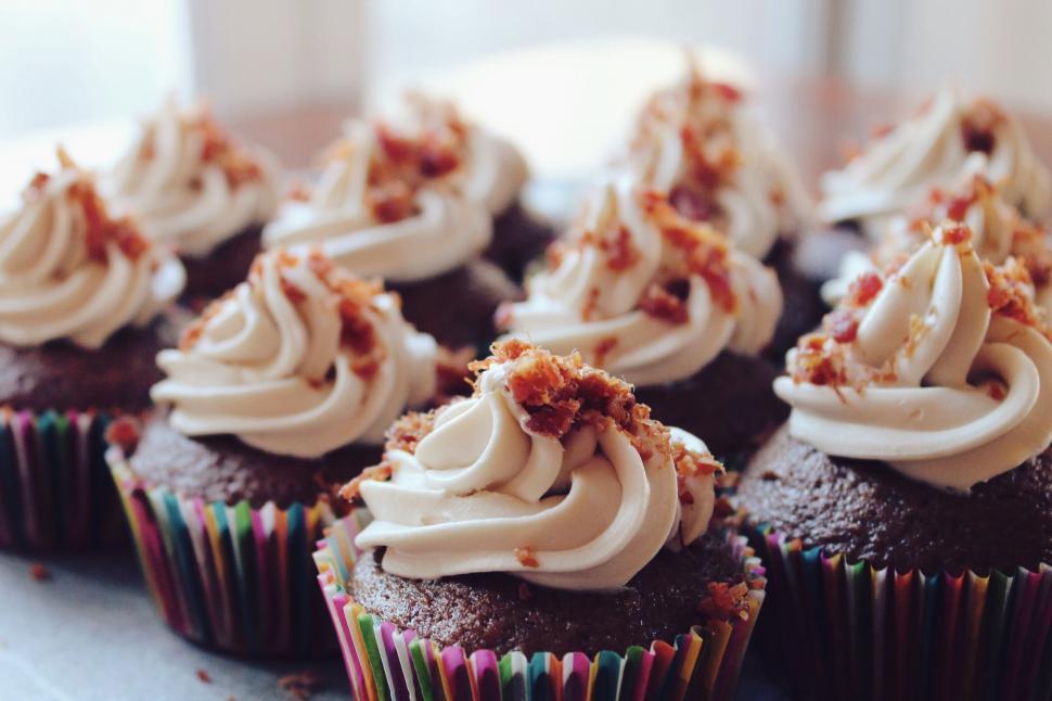 Free Image of Chocolate cupcakes with swirl frosting and nuts 