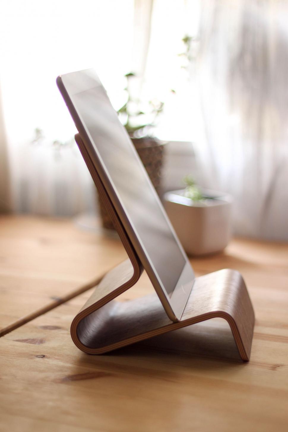 Free Image of Elegant wooden tablet stand on a desk 
