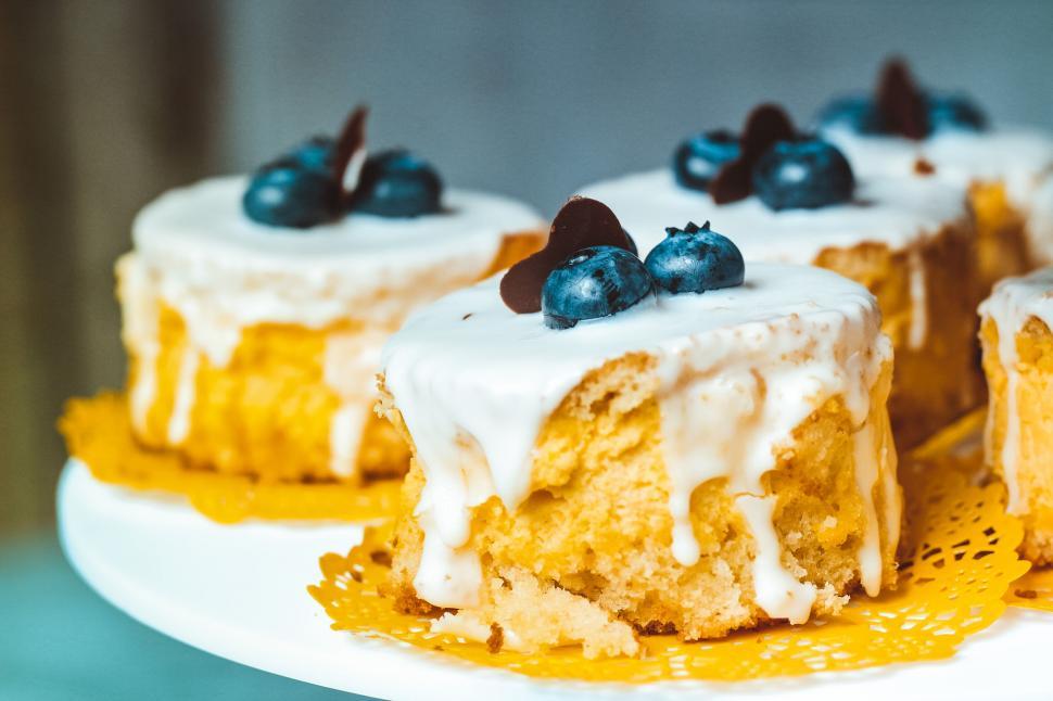 Free Image of Delicious blueberry cakes with dripping icing 