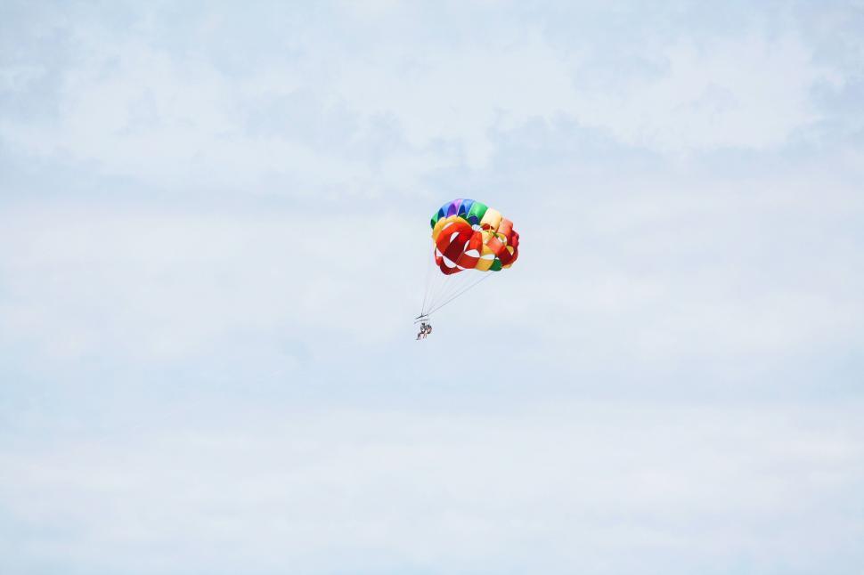 Free Image of Colorful parasailing against cloudy sky 