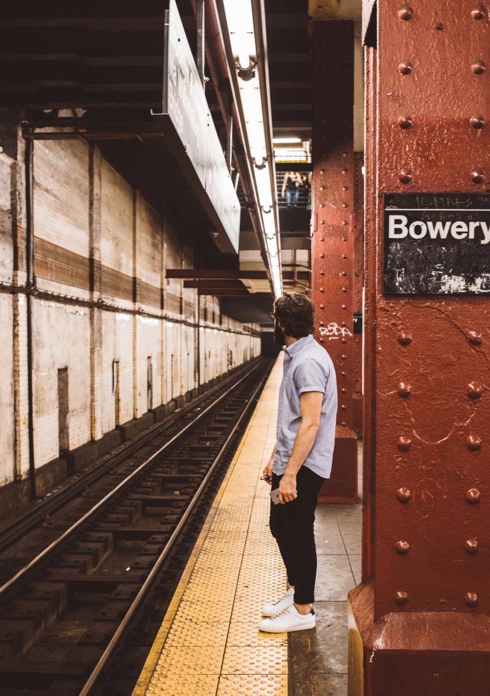 Free Image of Man waiting at a vintage subway station 