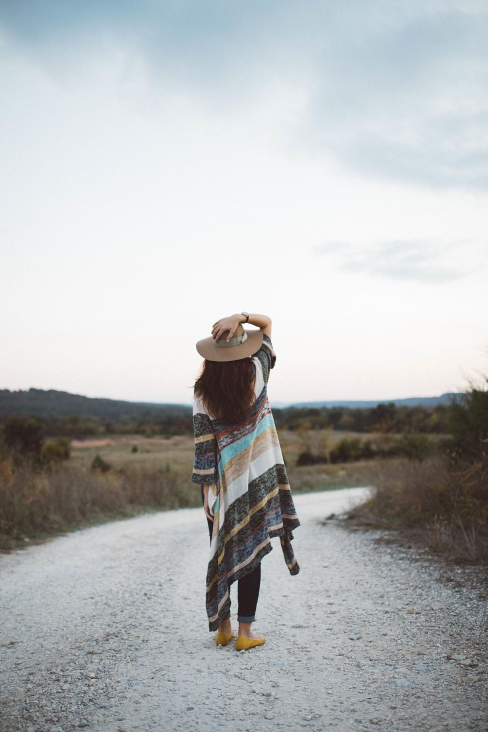 Free Image of Rustic woman standing on country road 
