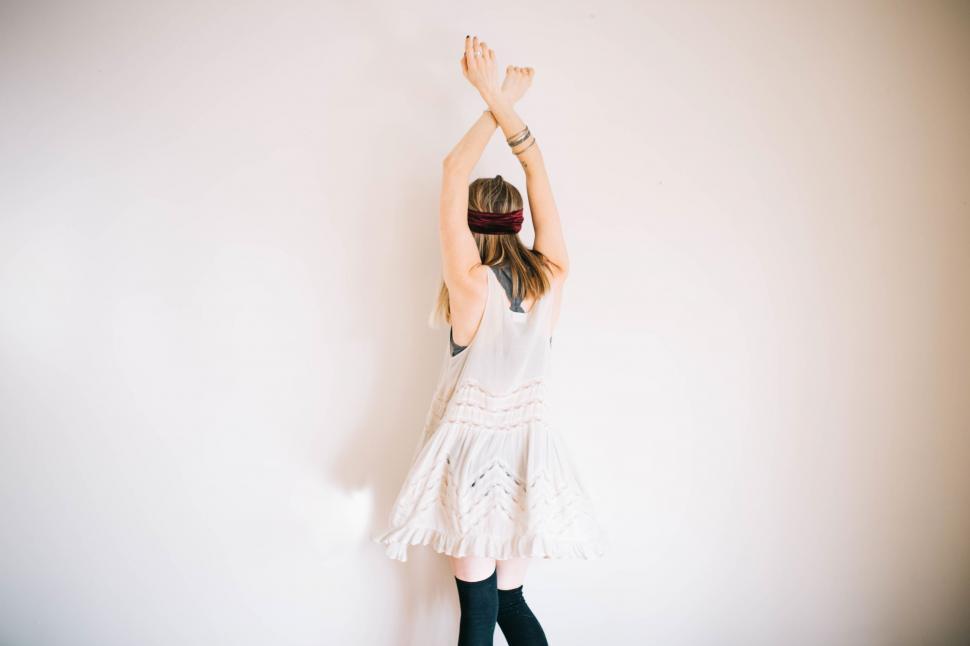 Free Image of Woman with arms raised in a peaceful pose 