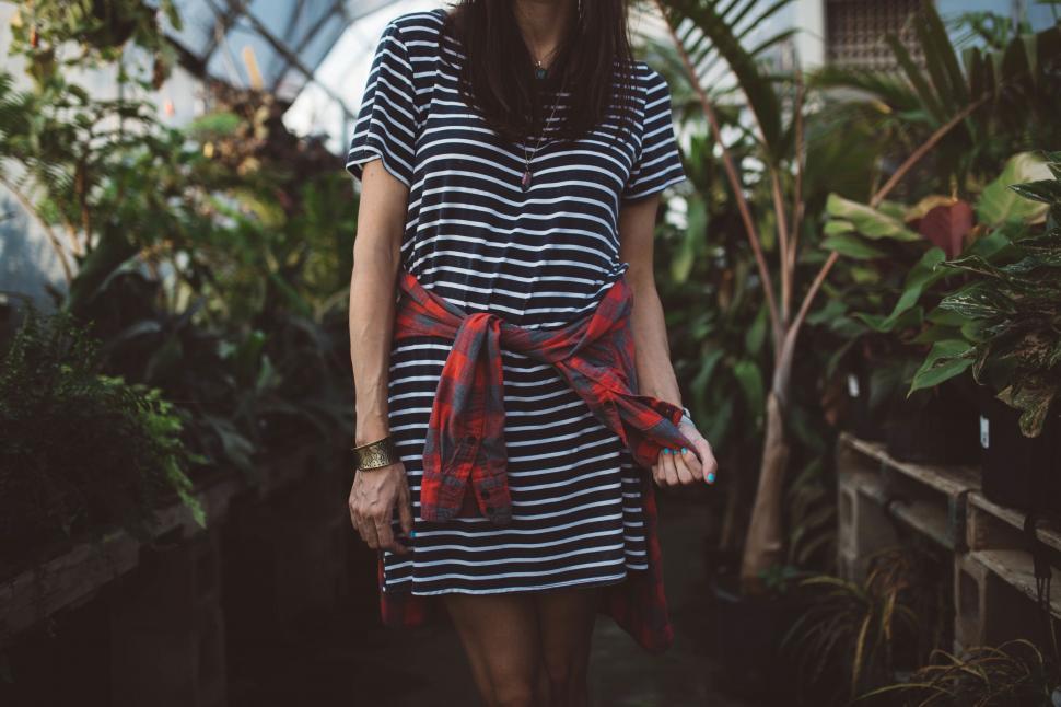 Free Image of Woman in striped dress with a flannel shirt 