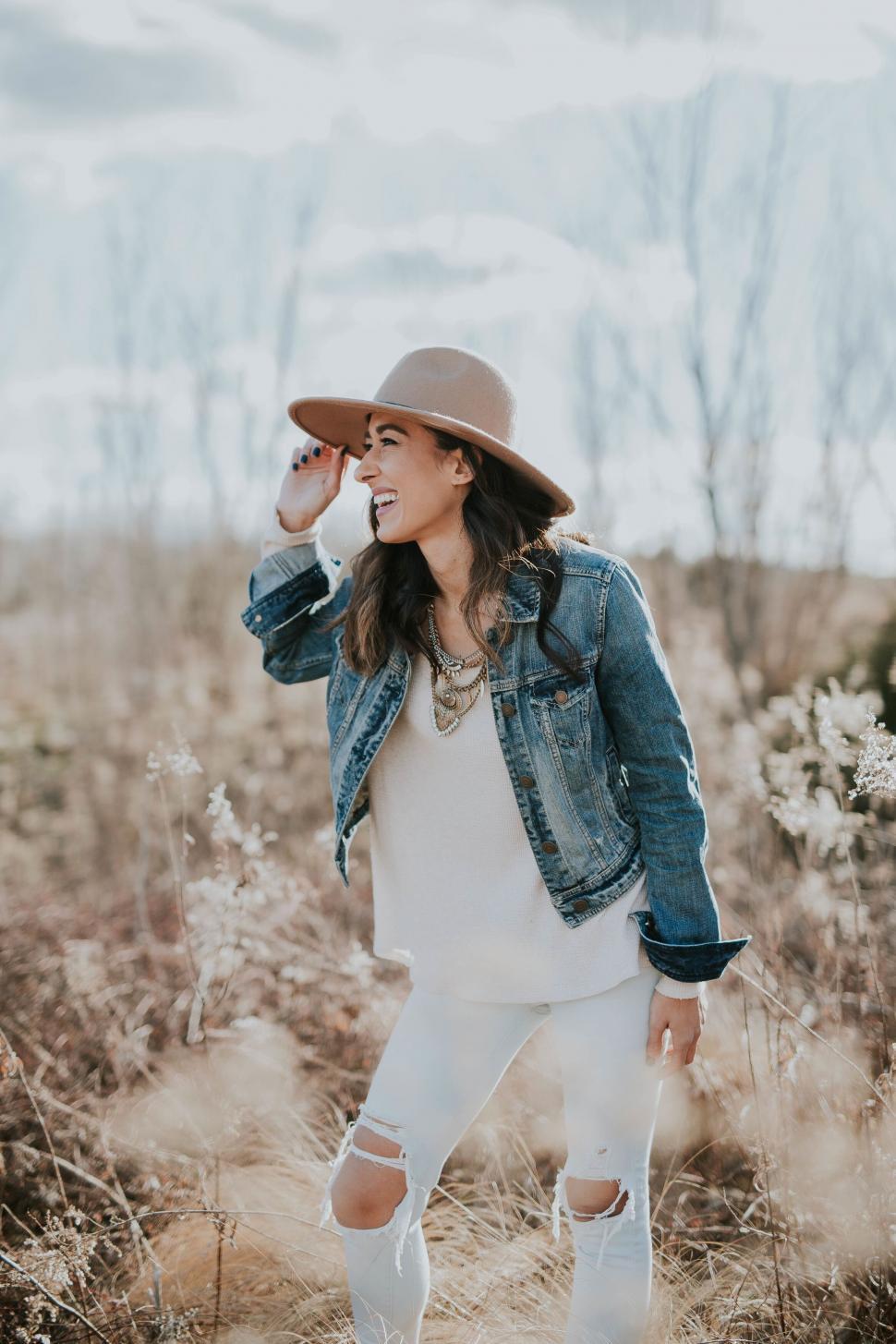 Free Image of Stylish woman in field with blurred face 