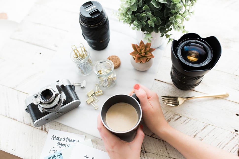 Free Image of Desk scene with camera and morning coffee 