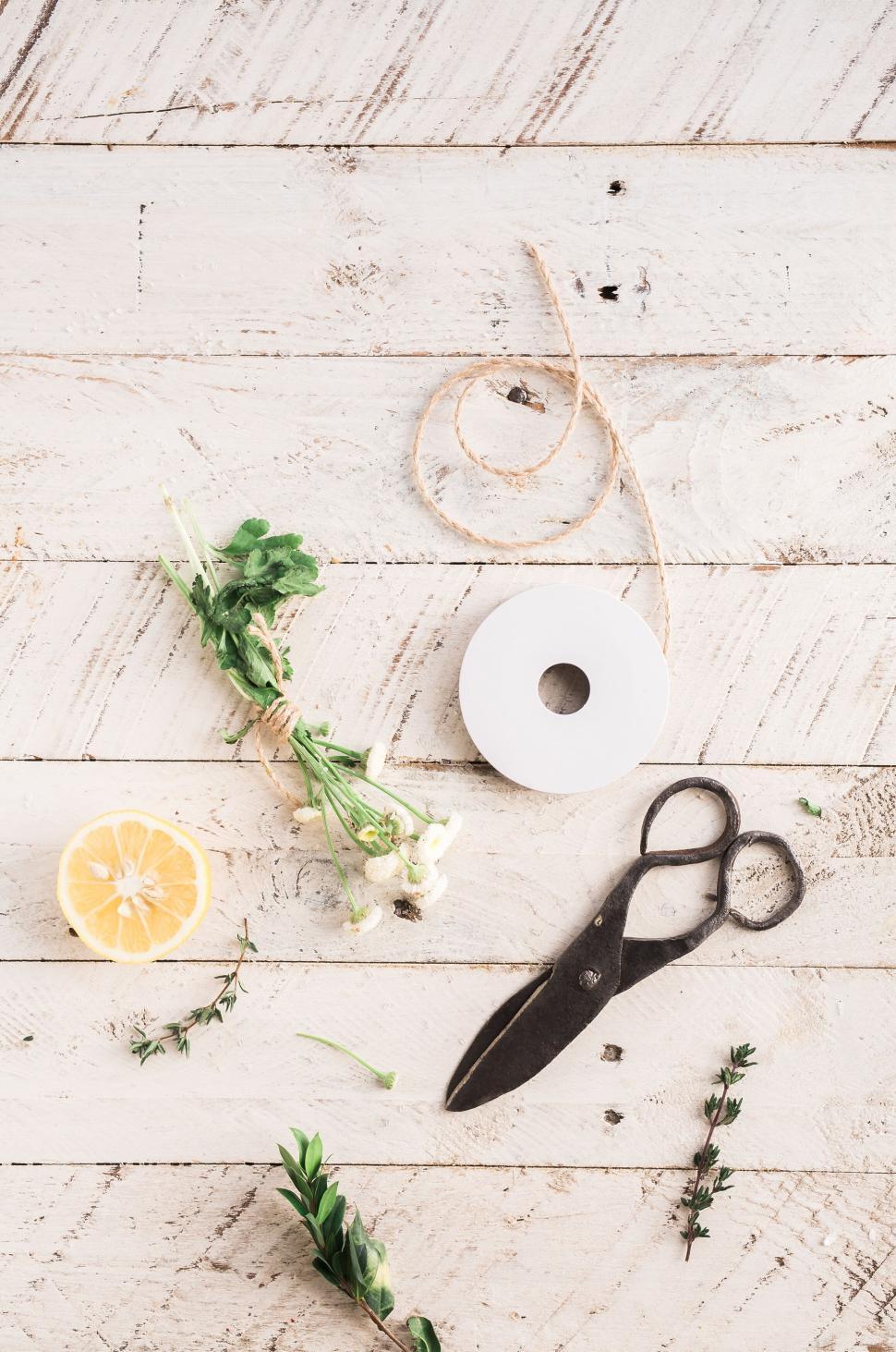 Free Image of Flat lay of craft supplies and herbs on wood 